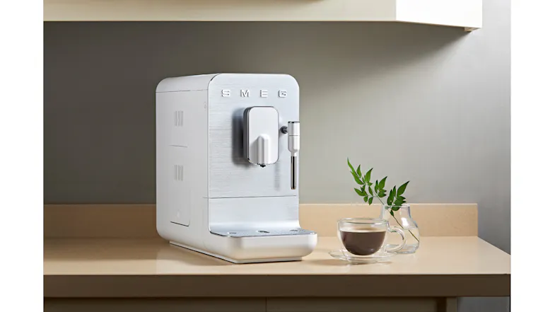 Countertop scene showcasing the Smeg appliance with a tall coffee drink Countertop scene showcasing the Smeg appliance with a tall coffee drink