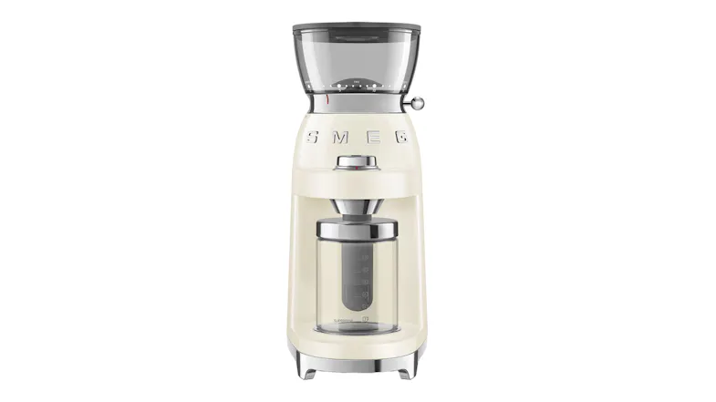 A front view of a black Smeg coffee grinder in glossy cream colour, with a transparent bean hopper and a clear ground coffee container A front view of a black Smeg coffee grinder in glossy cream colour, with a transparent bean hopper and a clear ground coffee container