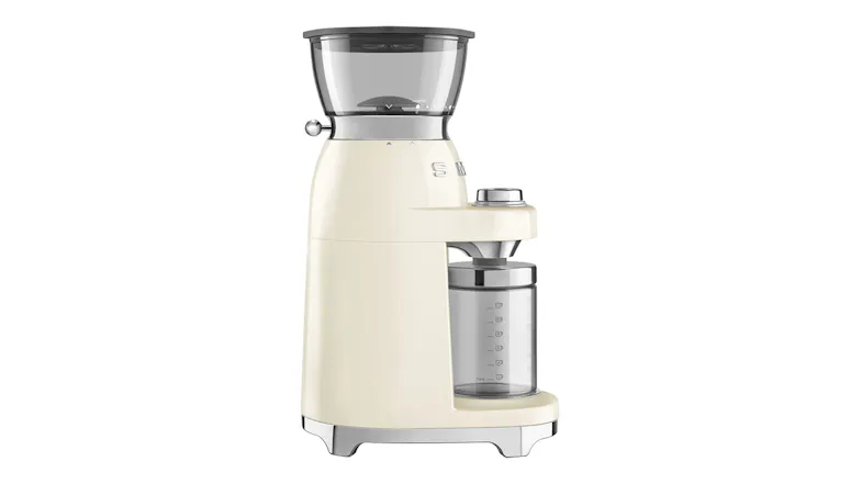 A side view of a sleek cream Smeg coffee grinder showing the grind size dial and a clear container with measurement markings A side view of a sleek cream Smeg coffee grinder showing the grind size dial and a clear container with measurement markings
