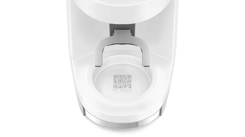 Bottom section of SMEG coffee grinder showing QR code labelled “My Smeg Assistant” on the drip tray area Bottom section of SMEG coffee grinder showing QR code labelled “My Smeg Assistant” on the drip tray area