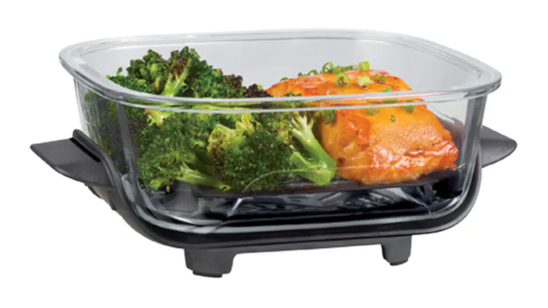 Side-profile view of a Ninja container with fresh broccoli and grilled fish inside Side-profile view of a Ninja container with fresh broccoli and grilled fish inside