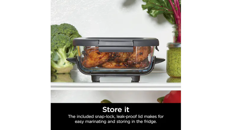 Front view of a person with oven mitts holding a roasted chicken Front view of a person with oven mitts holding a roasted chicken