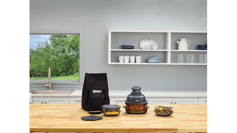 A wooden countertop showcasing the tote bag with an array of food containers A wooden countertop showcasing the tote bag with an array of food containers