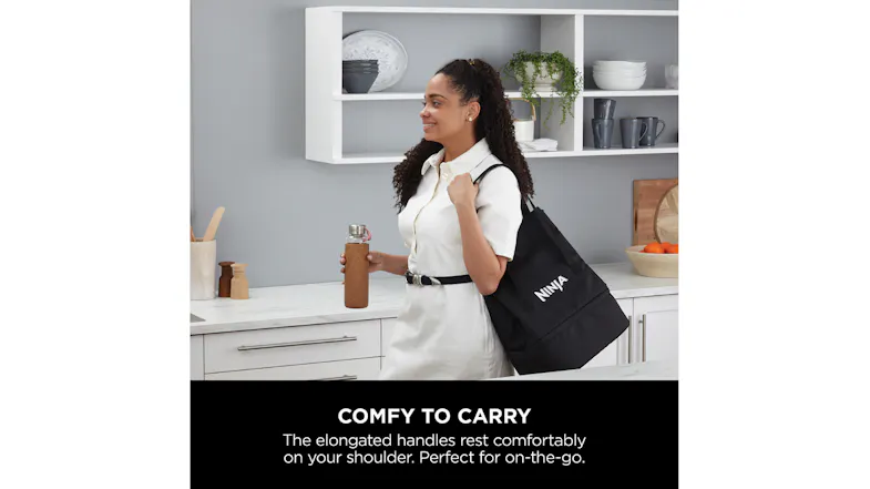 A woman carrying the black tote bag featuring the Ninja logo A woman carrying the black tote bag featuring the Ninja logo