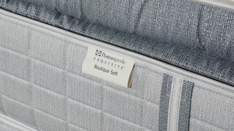 Detail of the fabric texture and the Sealy Posturepedic Boutique Soft label on the side of an extra long single mattress Detail of the fabric texture and the Sealy Posturepedic Boutique Soft label on the side of an extra long single mattress