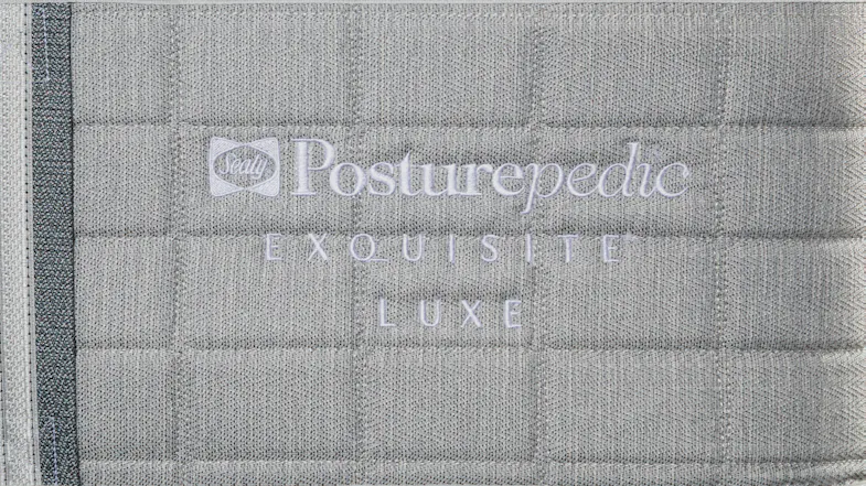 Direct view showing embroidered “Sealy Posturepedic Exquisite Luxe” text Direct view showing embroidered “Sealy Posturepedic Exquisite Luxe” text
