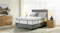 A double-sized Sleep Smart Graphite Soft mattress on an upholstered base in a well-lit bedroom setting A double-sized Sleep Smart Graphite Soft mattress on an upholstered base in a well-lit bedroom setting