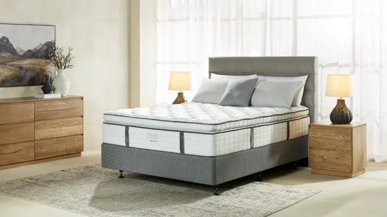 Full view of a Sleep Smart Graphite Medium mattress in a neutrally decorated bedroom Full view of a Sleep Smart Graphite Medium mattress in a neutrally decorated bedroom