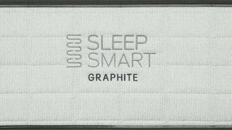 Embroidered “Sleep Smart Graphite” logo on light grey mattress fabric with horizontal stitching detail Embroidered “Sleep Smart Graphite” logo on light grey mattress fabric with horizontal stitching detail