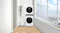 Bright sunroom showcasing a stacked laundry unit next to a window Bright sunroom showcasing a stacked laundry unit next to a window