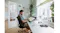 Side view of an artist working on a graphic layout featuring a tilted monitor Side view of an artist working on a graphic layout featuring a tilted monitor