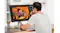 Back view of a man illustrating a cartoon character with a monitor Back view of a man illustrating a cartoon character with a monitor