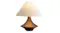 Bronze table lamp with sculpted base and light fabric shade, shown against a plain light background Bronze table lamp with sculpted base and light fabric shade, shown against a plain light background