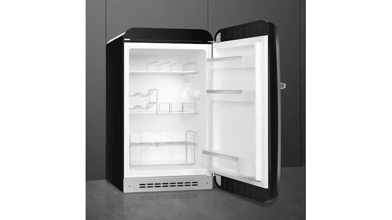 Smeg 50s Style mini fridge at an angled position with shelves, bottle rack, and door bins Smeg 50s Style mini fridge at an angled position with shelves, bottle rack, and door bins