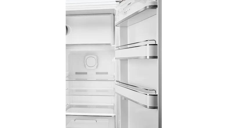 Close-up view of the Smeg refrigerator interior with glass shelves and chrome-trimmed door racks Close-up view of the Smeg refrigerator interior with glass shelves and chrome-trimmed door racks