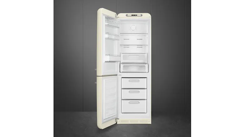 Full view of an open retro-style fridge showing empty shelves above and three freezer drawers below Full view of an open retro-style fridge showing empty shelves above and three freezer drawers below