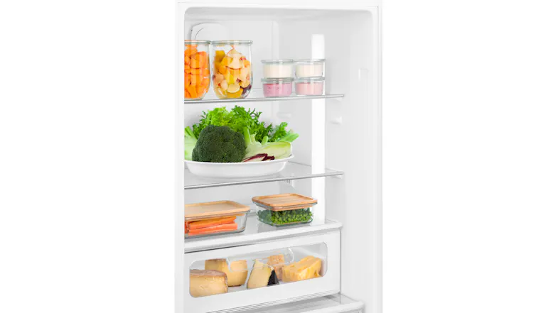 Inside view of Smeg 50s Style Refrigerator stocked with fresh greens, carrots, sliced cheese blocks, and jars of chopped fruit Inside view of Smeg 50s Style Refrigerator stocked with fresh greens, carrots, sliced cheese blocks, and jars of chopped fruit