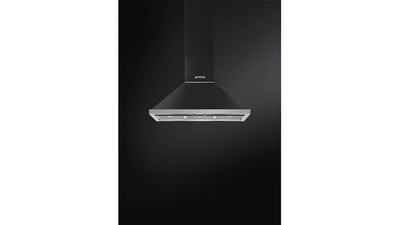 Black Smeg chimney hood, centred against a dark backdrop, with underside lights illuminating the filters below Black Smeg chimney hood, centred against a dark backdrop, with underside lights illuminating the filters below