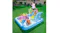 A top-down angled view of three kids playing in an inflatable water park pool on a green lawn with a woman A top-down angled view of three kids playing in an inflatable water park pool on a green lawn with a woman