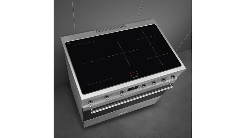 Top view of the induction cooktop with marked zones, touch controls, and a stainless steel control panel Top view of the induction cooktop with marked zones, touch controls, and a stainless steel control panel