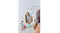 A woman using the mirror beside the makeup brushes A woman using the mirror beside the makeup brushes