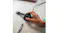 A hand is placing the kids' smartwatch on its charging dock A hand is placing the kids' smartwatch on its charging dock