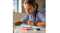 A girl studying at a table featuring the Pixbee Pro 2 smartwatch A girl studying at a table featuring the Pixbee Pro 2 smartwatch