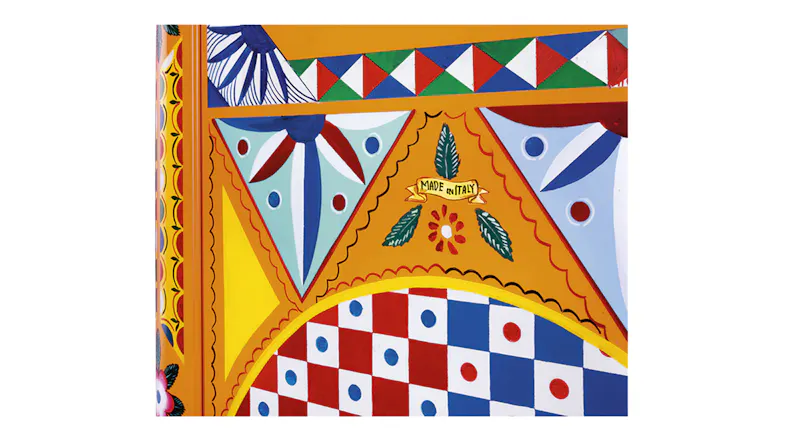 Detailed view of an SMEG 50s Style 270L single-door fridge with a chrome handle, checkered pattern, and circular wheel design in bright colours Detailed view of an SMEG 50s Style 270L single-door fridge with a chrome handle, checkered pattern, and circular wheel design in bright colours
