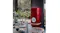 Stylish SMEG refrigerator with Porsche branding in dining space with plants and large glass windows Stylish SMEG refrigerator with Porsche branding in dining space with plants and large glass windows