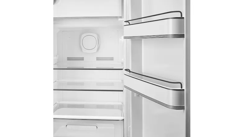 Empty Smeg refrigerator interior with glass shelves, drawers, and door bins, clean and white Empty Smeg refrigerator interior with glass shelves, drawers, and door bins, clean and white