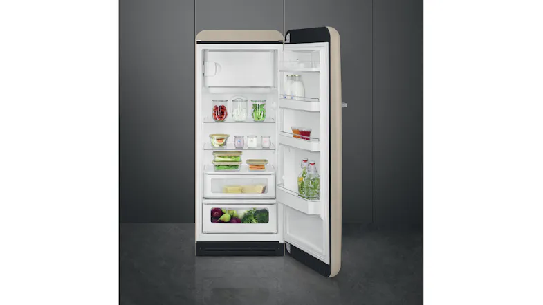 Retro-style fridge open and organised with jars, produce, drinks, and bottles on shelves and in the door Retro-style fridge open and organised with jars, produce, drinks, and bottles on shelves and in the door