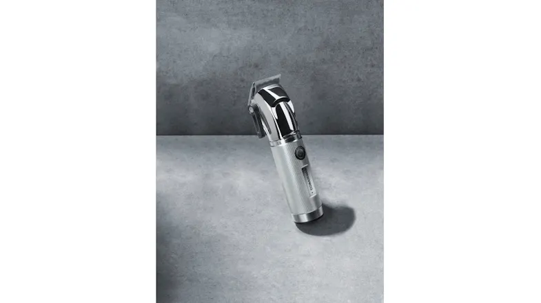 The Chrome Pro cordless hair clipper is standing on a textured surface with a premium metallic finish The Chrome Pro cordless hair clipper is standing on a textured surface with a premium metallic finish