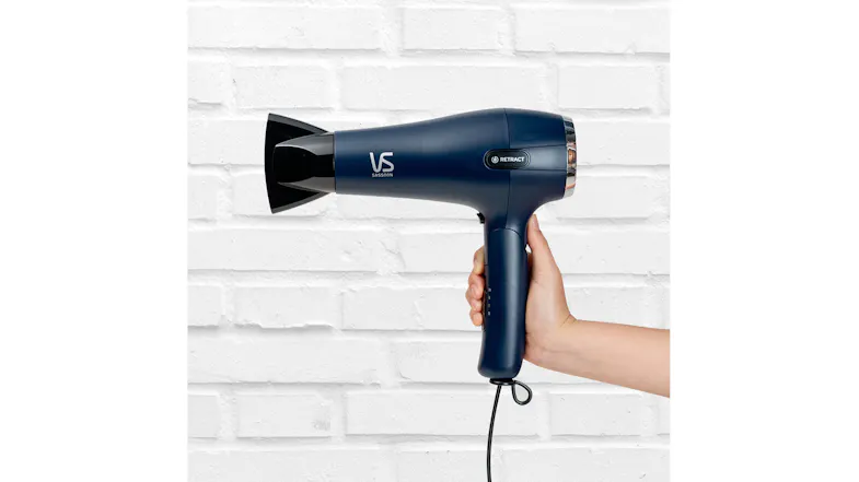 A view of a hand holding the hair dryer A view of a hand holding the hair dryer