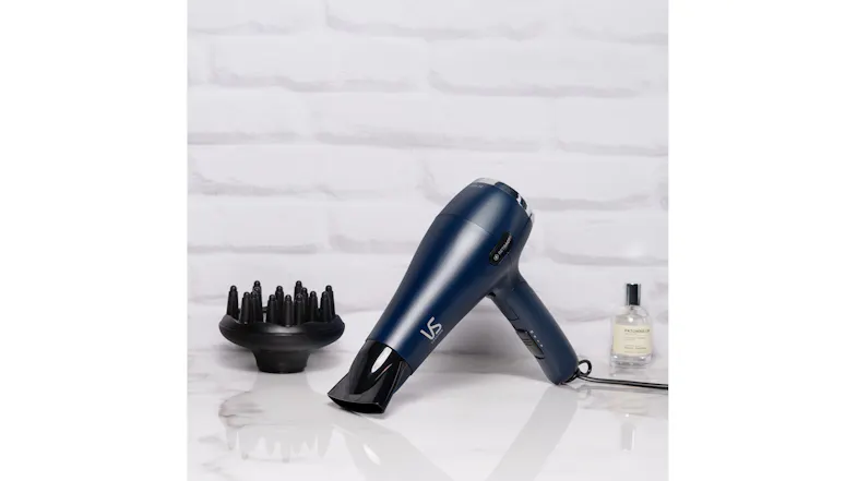 The hair dryer is propped on a surface along with its included diffuser attachment The hair dryer is propped on a surface along with its included diffuser attachment