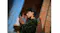 Profile view of a person wearing an earbud near a wall Profile view of a person wearing an earbud near a wall