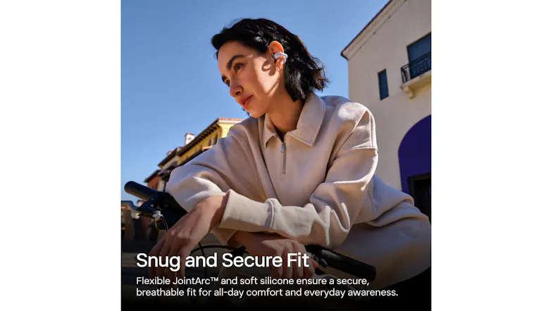 A person leaning against a bicycle structure while wearing wireless earbuds A person leaning against a bicycle structure while wearing wireless earbuds