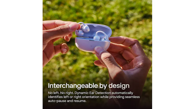 Close-up view of hands holding an open charging case outdoors Close-up view of hands holding an open charging case outdoors