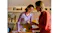 Indoor view of two women wearing earbuds discussing paperwork together Indoor view of two women wearing earbuds discussing paperwork together