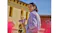 Side view of a person holding flowers with Shokz open-ear earbuds Side view of a person holding flowers with Shokz open-ear earbuds