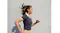 Profile view of a person wearing an earbud while running against a plain wall Profile view of a person wearing an earbud while running against a plain wall
