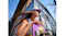Low-angle view of a person holding a purple skateboard with matching earbuds Low-angle view of a person holding a purple skateboard with matching earbuds