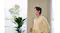 Profile view of a man standing indoors wearing black earbuds Profile view of a man standing indoors wearing black earbuds
