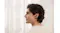 Side profile view of a person wearing a Shokz earbud Side profile view of a person wearing a Shokz earbud