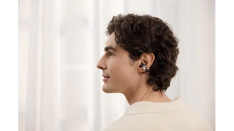 Side profile view of a person wearing a Shokz earbud Side profile view of a person wearing a Shokz earbud