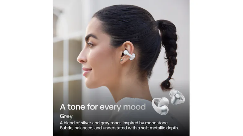 Profile view of a person wearing earbuds against a dark background Profile view of a person wearing earbuds against a dark background