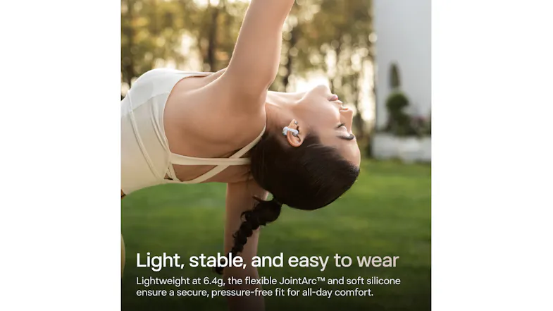 Dynamic view of a person wearing an earbud while stretching outdoors Dynamic view of a person wearing an earbud while stretching outdoors