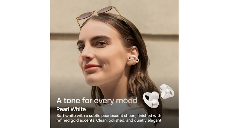 Profile view of a person standing near a building wall with an earbud Profile view of a person standing near a building wall with an earbud