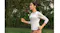 Full-body profile view of a person jogging outdoors with an earbud Full-body profile view of a person jogging outdoors with an earbud