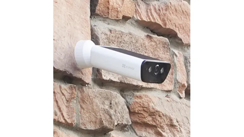 Wire-free security camera mounted on a stone exterior wall, demonstrating weather-resistant construction Wire-free security camera mounted on a stone exterior wall, demonstrating weather-resistant construction