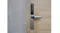 Close-up of the water-resistant EZVIZ smart door lock covered in raindrops on a wooden door Close-up of the water-resistant EZVIZ smart door lock covered in raindrops on a wooden door